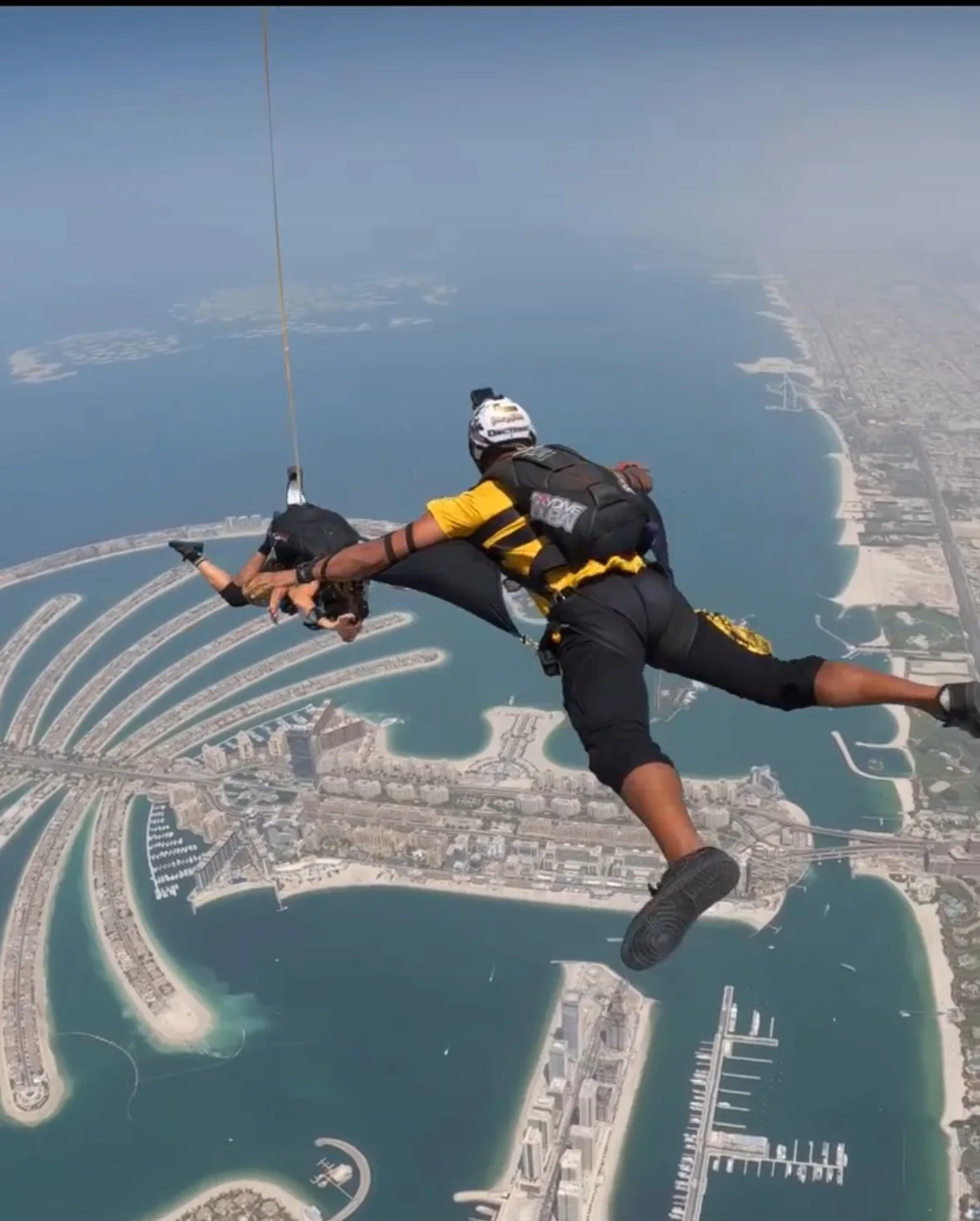 Camera flyer wearing Skeleton Camera Jacket over Palm Jumeirah